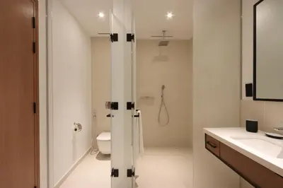 a bathroom with a shower and a toilet and a sink at Livbnb - Modern 3BR with Marina & Sunset View in Dubai