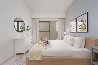 a white bedroom with a bed and a mirror at Maison Privee - Modern Chic Apt with Unobstructed Burj Khalifa Views in Dubai