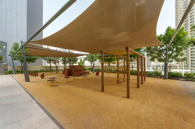 a pavilion with a bench and a swing at Maison Privee - Modern Chic Apt with Unobstructed Burj Khalifa Views in Dubai