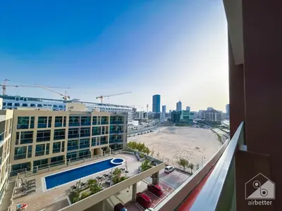 a view from the balcony of a building with a pool at Modern & Chic studio with Balcony Dubai in Dubai