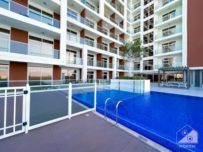 a swimming pool in front of a building at Modern & Chic studio with Balcony Dubai in Dubai