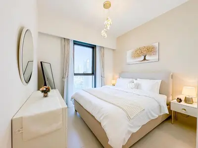a white bedroom with a large bed and a window at First Class Stay in Downtown Dubai Near Burj Park by SBH in Dubai