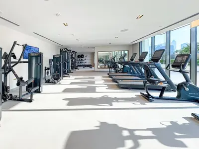 a gym with cardio equipment and treadmills at First Class Stay in Downtown Dubai Near Burj Park by SBH in Dubai