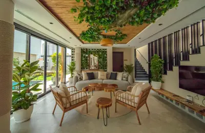 a living room with a couch and a table and chairs at Nas House Private & Shared Villas in Dubai