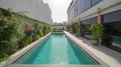 a swimming pool on the side of a building at Nas House Private & Shared Villas in Dubai