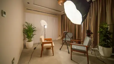 a room with chairs and a camera and plants at Nas House Private & Shared Villas in Dubai