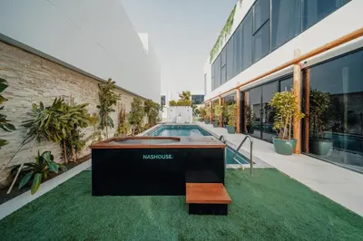 a swimming pool in the middle of a building at Nas House Private & Shared Villas in Dubai