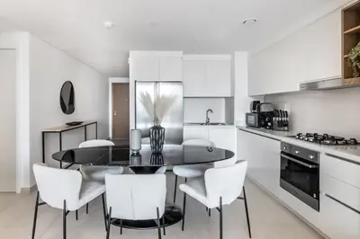a kitchen with a dining room table and chairs at The Smart Concierge - Downtown views 2 in Dubai