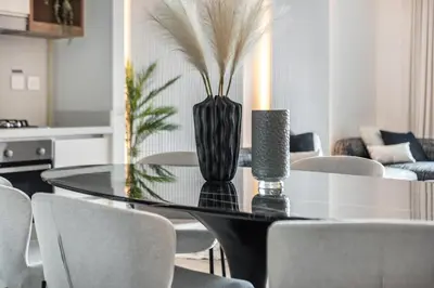 a dining room with a glass table and chairs at The Smart Concierge - Downtown views 2 in Dubai