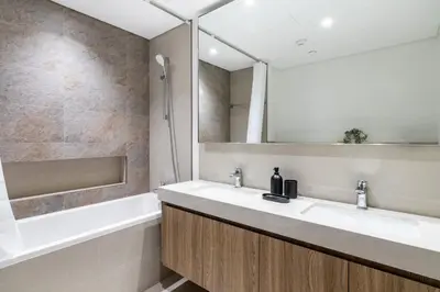 a bathroom with two sinks and a tub and a mirror at The Smart Concierge - Downtown views 2 in Dubai