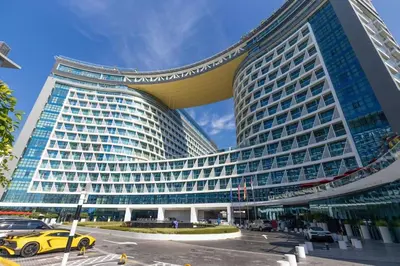 a large building with a yellow car in front of it at Modern 1 bedroom at Palm Jumeirah in Dubai