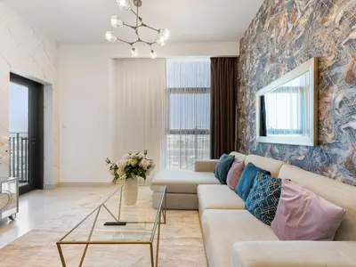 a living room with a couch and a table at Modern Comforts -1 BR in Park Point- Dubai Hills in Dubai