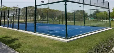 a tennis court with a net on a field at Carson Tower C - Damac Hills by Golden Casa in Dubai