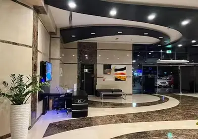 an office with a desk and a tv in a room at Cosmos Living Cozy Studio GCV2 in Dubai