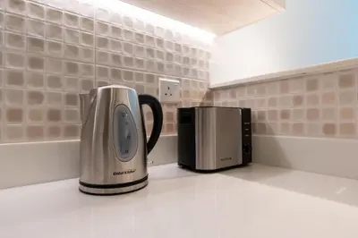a coffee maker and a toaster on a counter at The Seven Palm in Dubai