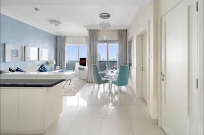 a kitchen and dining room with a table and chairs at LUX 1 bed flat with Burj Khalifa View - 3 minute walk to Dubai Mall - Best Location - Best Balcony View in Dubai