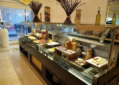 a buffet line with food in a restaurant at LUX 1 bed flat with Burj Khalifa View - 3 minute walk to Dubai Mall - Best Location - Best Balcony View in Dubai
