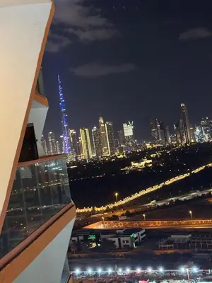 a view of a city skyline at night at Binghatti avenue in Dubai