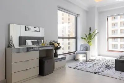 a white room with a vanity and a chair in it at Stylish 3bdr apartment in Rimal 2 JBR in Dubai