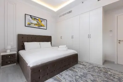 a bedroom with a large bed in a white room at Stylish 3bdr apartment in Rimal 2 JBR in Dubai