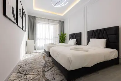 a bedroom with two beds and a large window at Stylish 3bdr apartment in Rimal 2 JBR in Dubai
