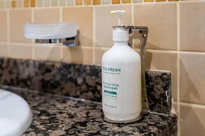 a bottle of detergent sitting on a bathroom counter at Spacious, Deluxe, 5BR plus maidroom on JBR walk Next to Beach ,Tram & Mall by La Buena Vida Holiday Homes in Dubai