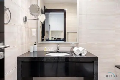 a bathroom with a sink and a mirror at Gorgeous Studio Apartment in DAMAC Celestia B Dubai South by Deluxe Holiday Homes in Dubai