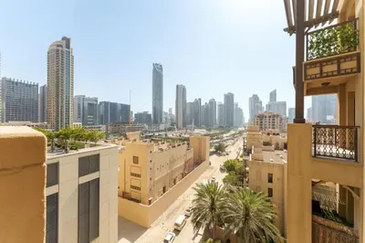 a view of a city with buildings and palm trees at Green living chic 1 bedroom apartment in Dubai