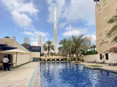 a pool with a view of the oriental pearl tower at Green living chic 1 bedroom apartment in Dubai