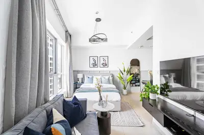 a bedroom with a bed and a couch at Silkhaus Studio at Dubai Marina Near Marina Mall in Dubai