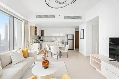 a living room with a white couch and a table at Silkhaus Elite 2BDR with View with Pool & Gym in Dubai
