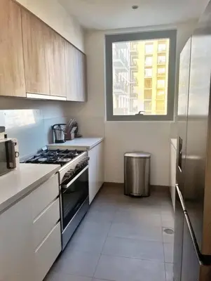 a small kitchen with a stove and a window at 3 bedrooms + maids room, Full Park view in Dubai