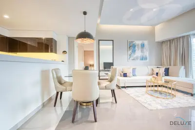 a living room with a couch and a table at Overlooking Canal Views, Fam-Friendly 2BR Unit, Damac Majestine Tower, Business Bay by Deluxe Holiday Homes in Dubai