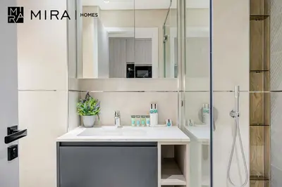 a bathroom with a sink and a shower at Mira Holiday Homes-Cozy studio close to metro in Dubai