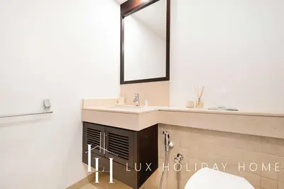 a bathroom with a sink and a mirror at LUX The Stunning Fountain View Suite in Dubai
