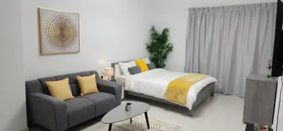 a living room with a bed and a couch at Elite 6 Residence - Sports City by Golden Casa in Dubai