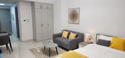 a living room with a bed and a couch at Elite 6 Residence - Sports City by Golden Casa in Dubai