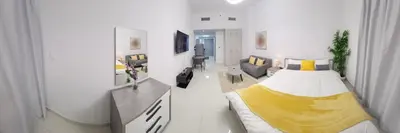 a bedroom with a bed and a living room at Elite 6 Residence - Sports City by Golden Casa in Dubai
