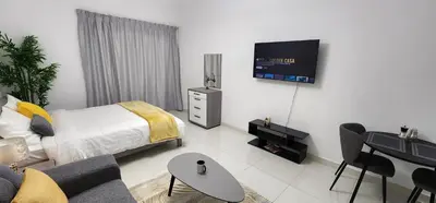 a living room with a bed and a tv on the wall at Elite 6 Residence - Sports City by Golden Casa in Dubai