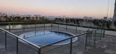 a hot tub on the roof of a building at Shaista Azizi Residence - Al Furjan by Golden Casa in Dubai