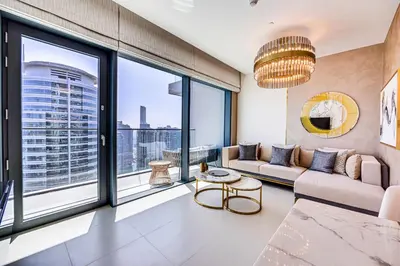 a living room with a couch and a large window at Breathtaking views from Vida Dubai Marina in Dubai