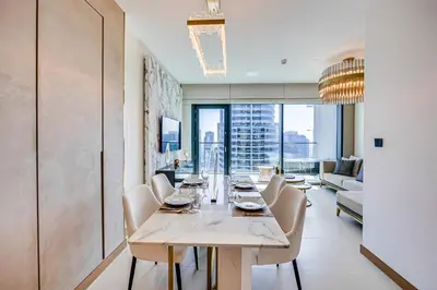 a dining room with a long table and chairs at Breathtaking views from Vida Dubai Marina in Dubai