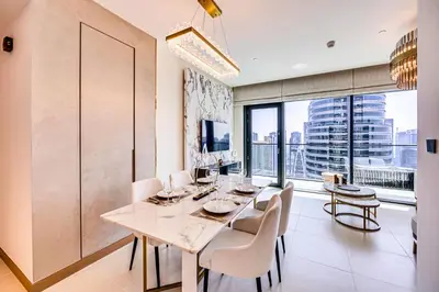 a dining room with a table and chairs and a large window at Breathtaking views from Vida Dubai Marina in Dubai