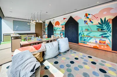 a living room with a couch and a colorful wall at Breathtaking views from Vida Dubai Marina in Dubai