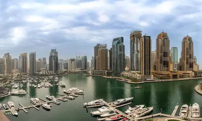 a view of a city with boats in a harbor at Panoramic canal views from brand new 3BD apartment in Dubai
