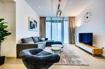 a living room with a couch and a tv at Panoramic canal views from brand new 3BD apartment in Dubai