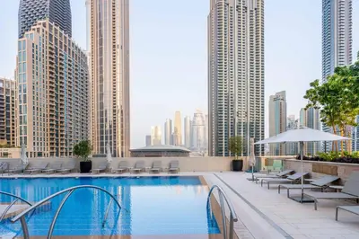 a swimming pool on the roof of a building with tall buildings at GuestReady - Glamourous home in Downtown Dubai in Dubai