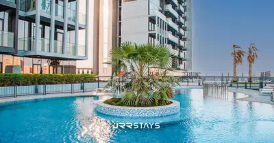 a swimming pool in the middle of a building at Upgraded 1BR Apartment in Bloom Tower B - JVC in Dubai