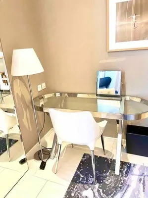a glass table with a white chair and a lamp at Best View Security System Burj Kalifa View in Dubai