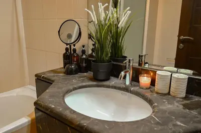 a bathroom counter with a sink and a mirror at Downtown Dubai Mall walk & Burj Khalifa DIFC 5 mins in Dubai